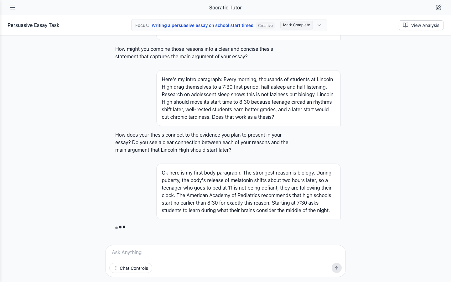 The essay chat with three bouncing dots under the student's latest message while the tutor's reply is generated